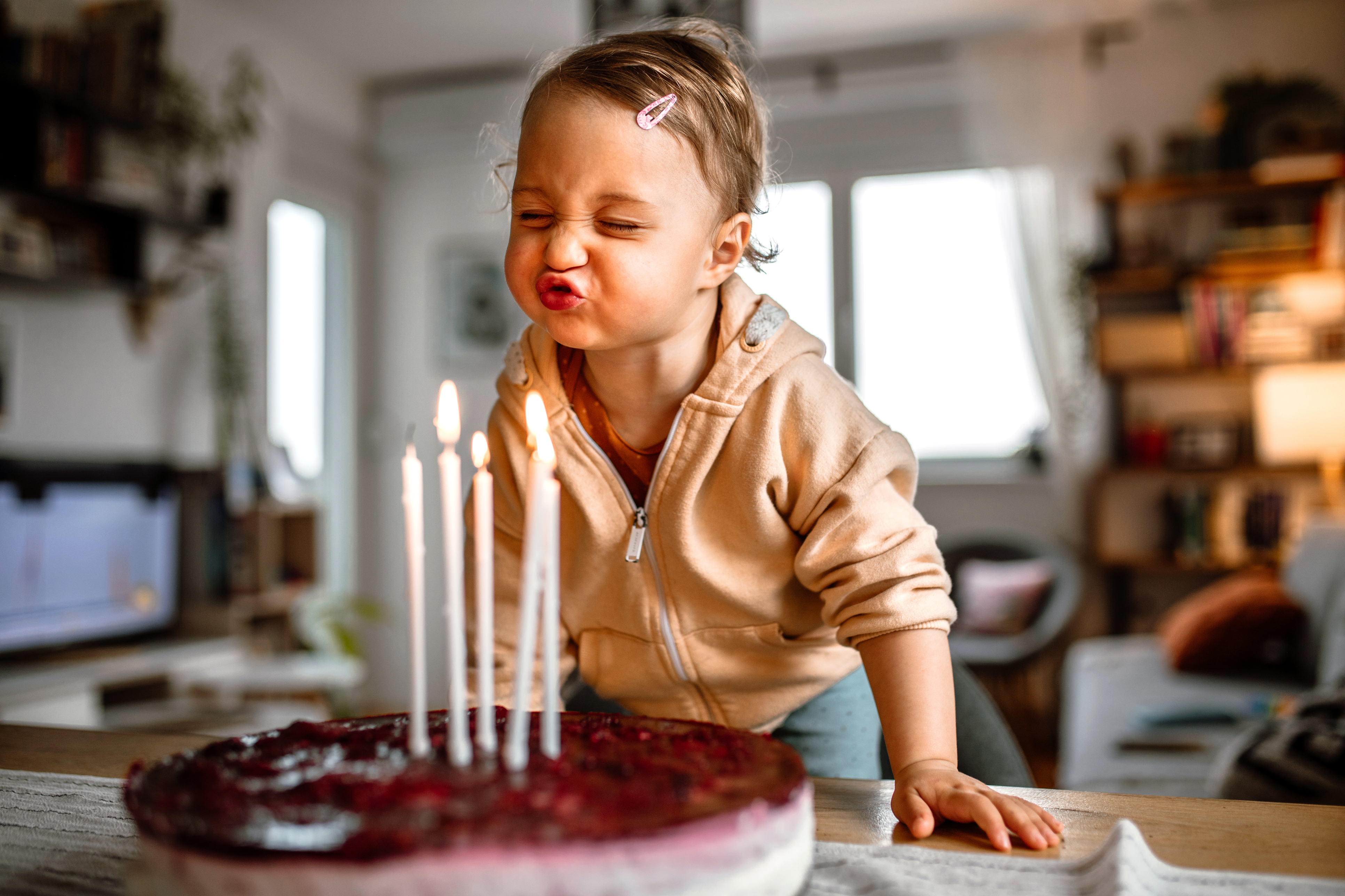 Toddler blowing birthday candles