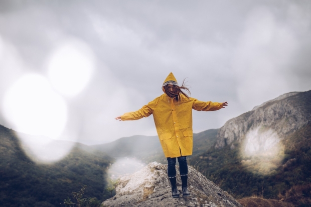 Girl hiking on mountain in the rain